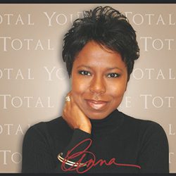 Anna Walker ACC MBA headshot photo, dark haired woman smiling in front of a tan background