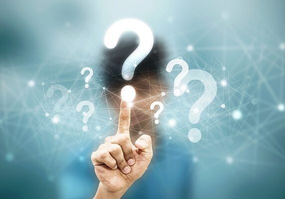 hand touching overlayed question mark surrounded by other question marks and connected dots