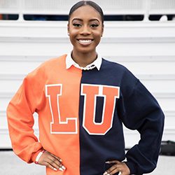 Elisabeth Bellevue headshot photo, woman smiling with a LU sweater on in front of a white background