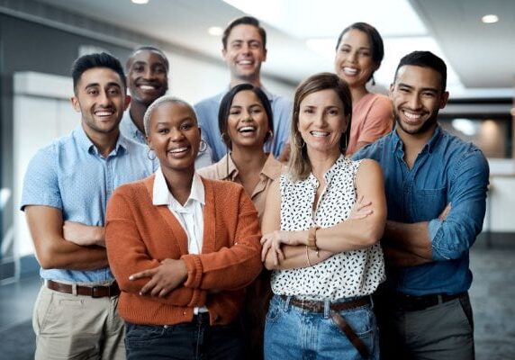 group of people posing for a photo with arms crossed across their chest smiling