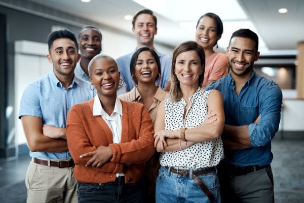 group of people posing for a photo with arms crossed across their chest smiling