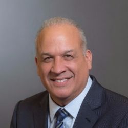 Robert Garcia ACC MBA headshot photo, man with white hair in professional attire smiling