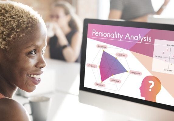 woman sitting at a computer screen with her personality analysis graphic