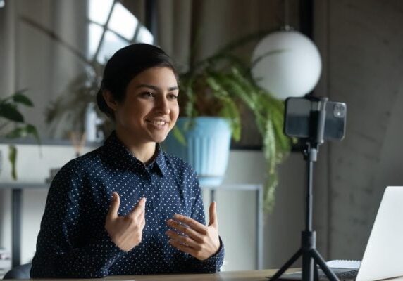 coach filming speaking with a cellphone for use online