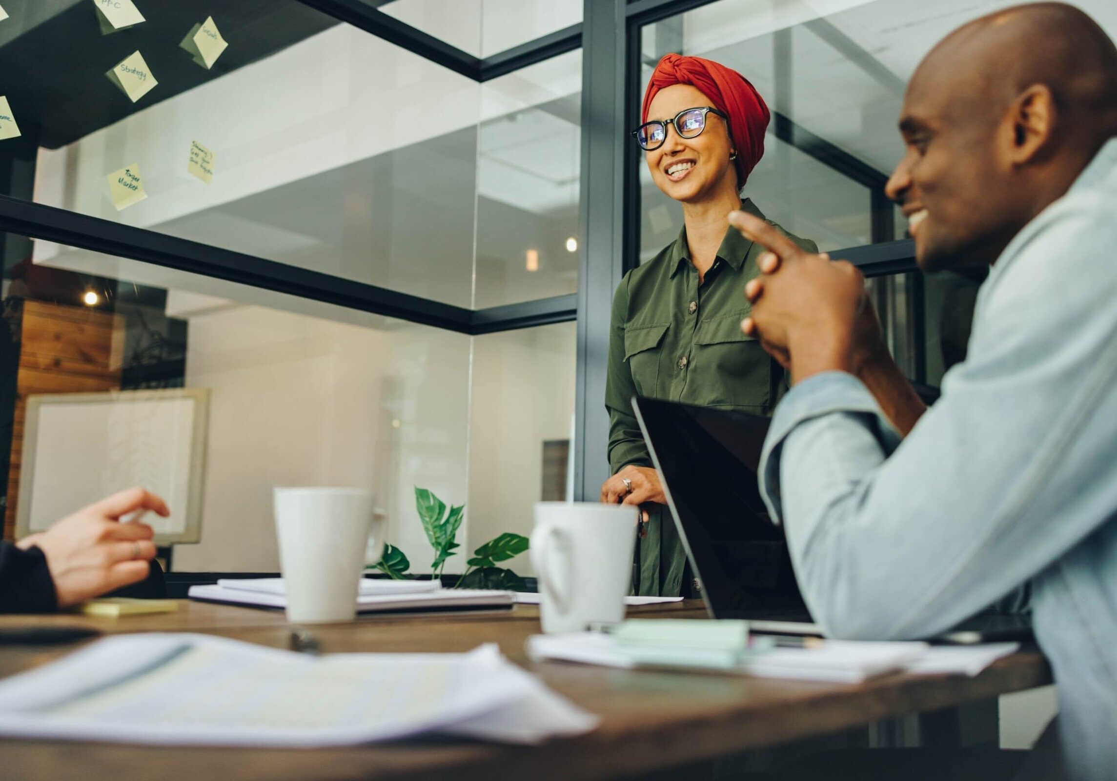 Professional leading a discussion during a team meeting in an office