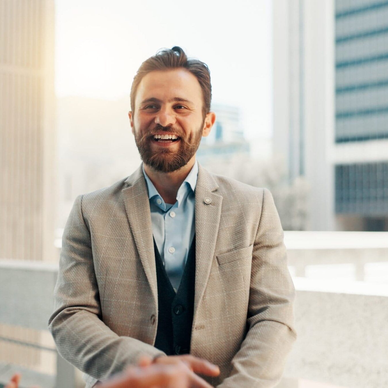 Business professionals shaking hands during a meeting in a modern office