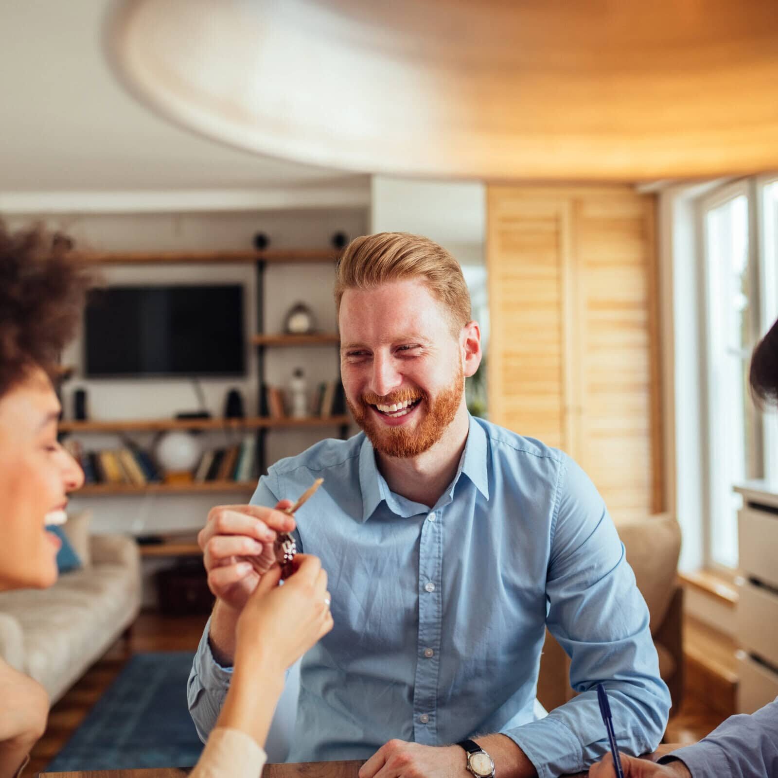 Couple smiling with a friend at home