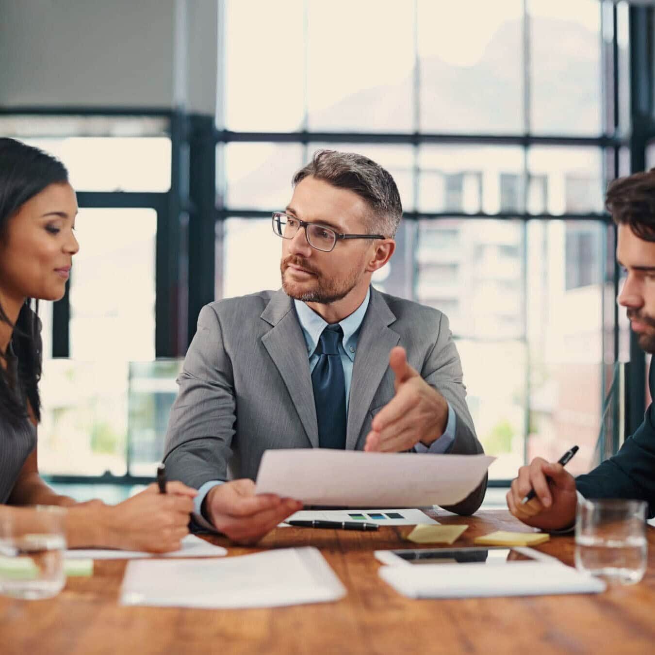 A group of professionals go through the ACTC structure in an office setting