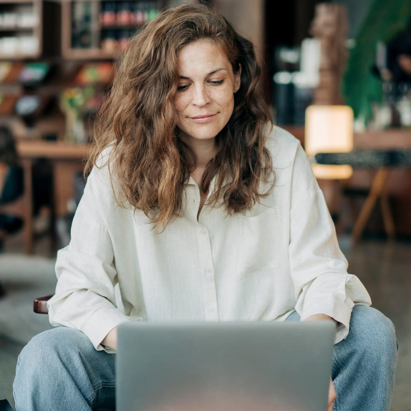 Professional woman working on a laptop in a café