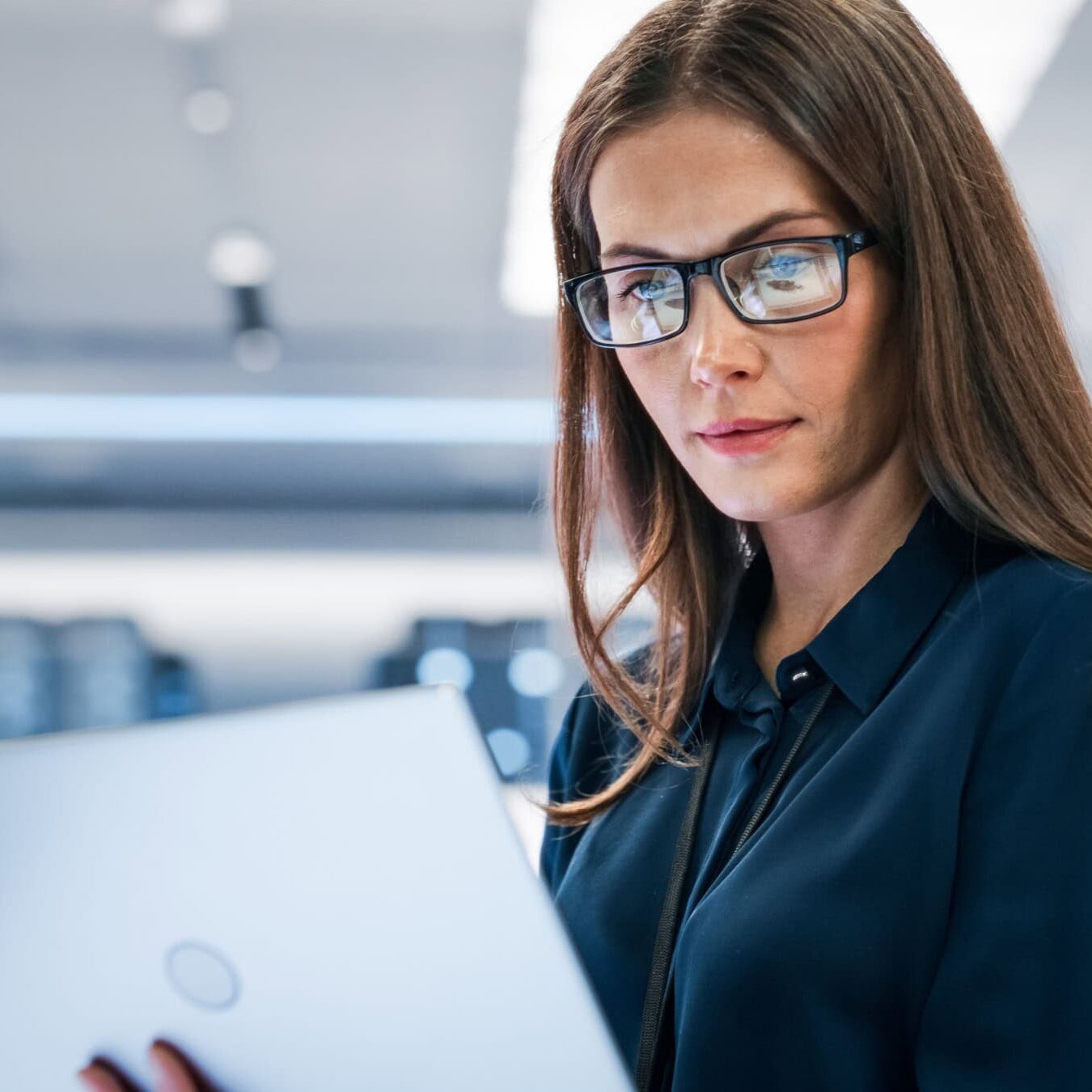 A woman views her laptop to verify her coaching experience.