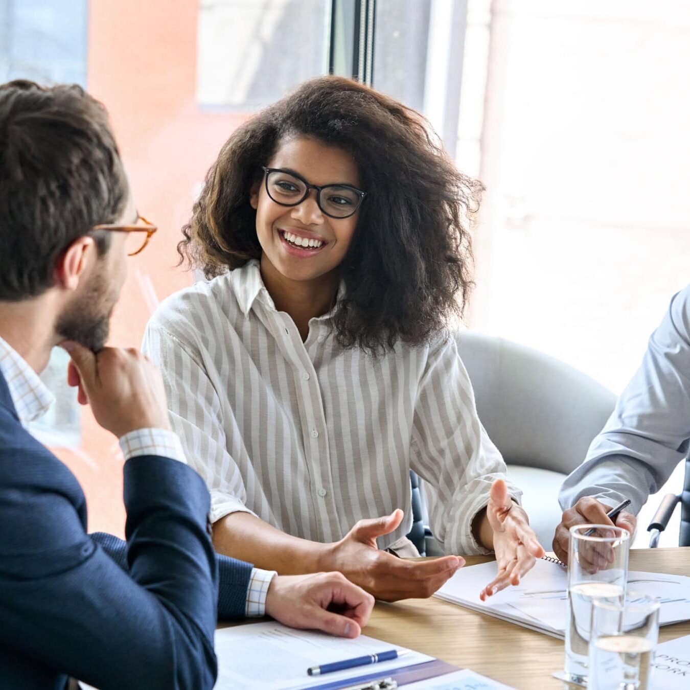 A group of professional coaches work together in an office to determine next steps