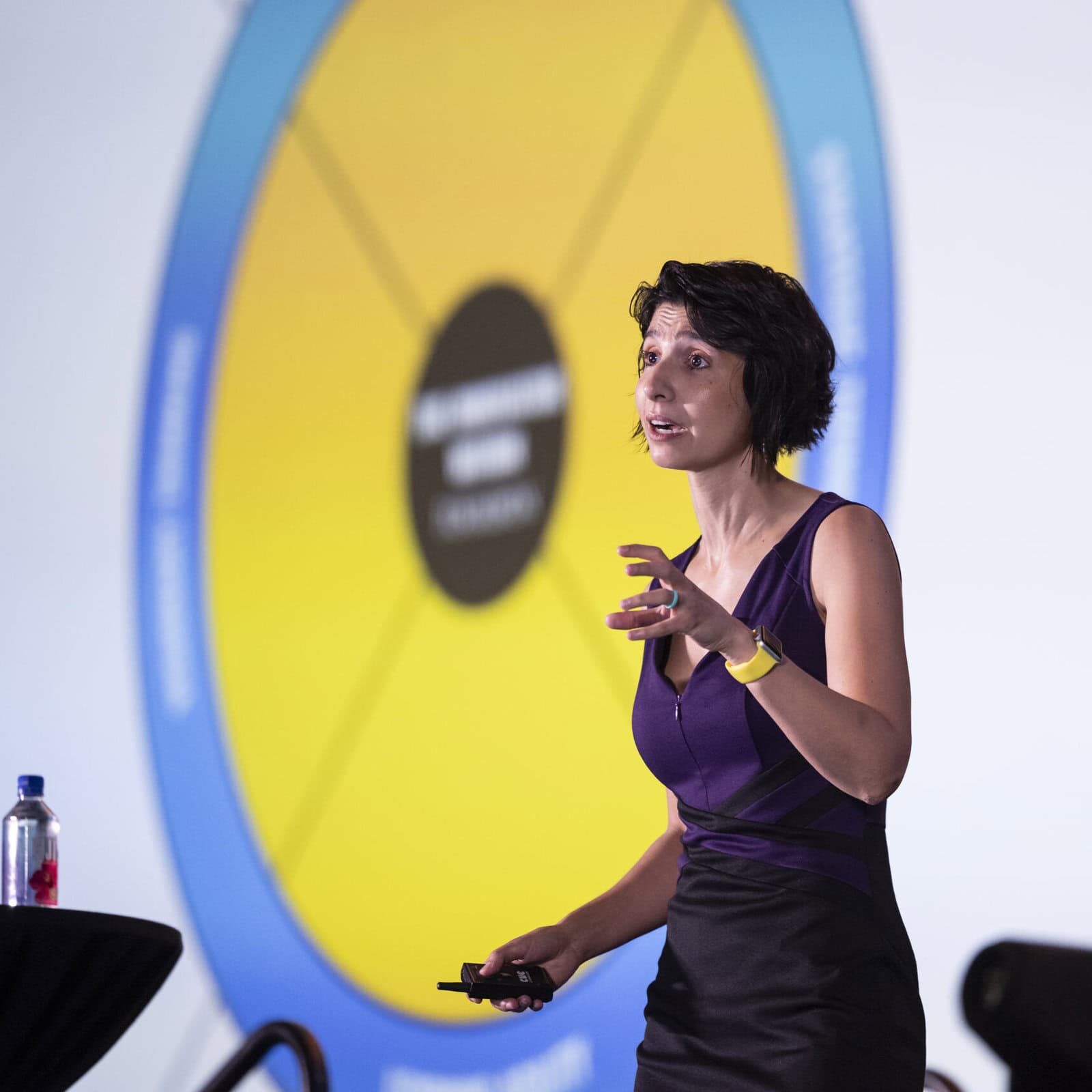 Coaching experts speaking on a panel at an ICF event, discussing trends and challenges in the industry