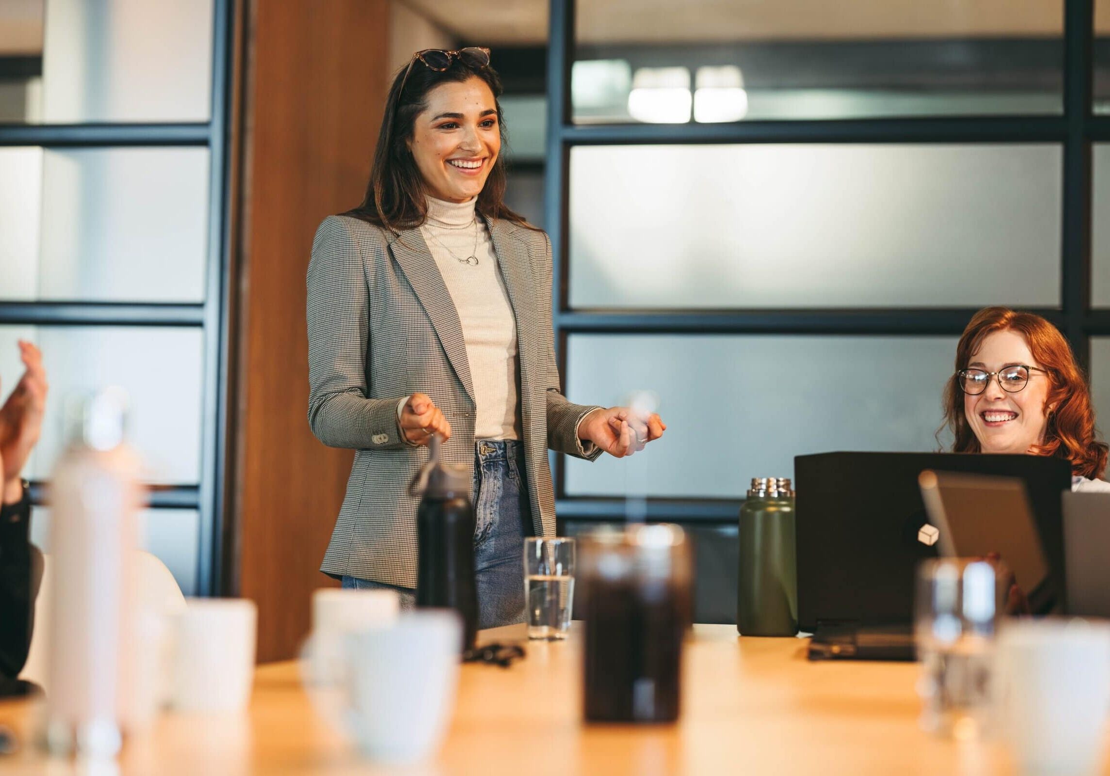 Woman standing and speaking during business meeting in office