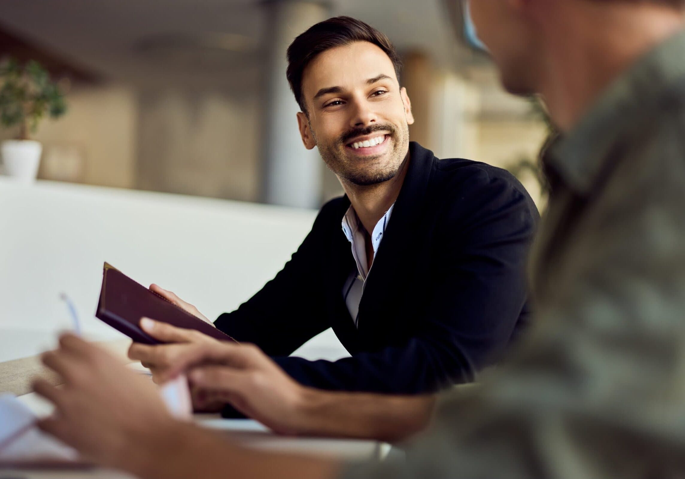 Professional man smiling during a one-to-one business conversation