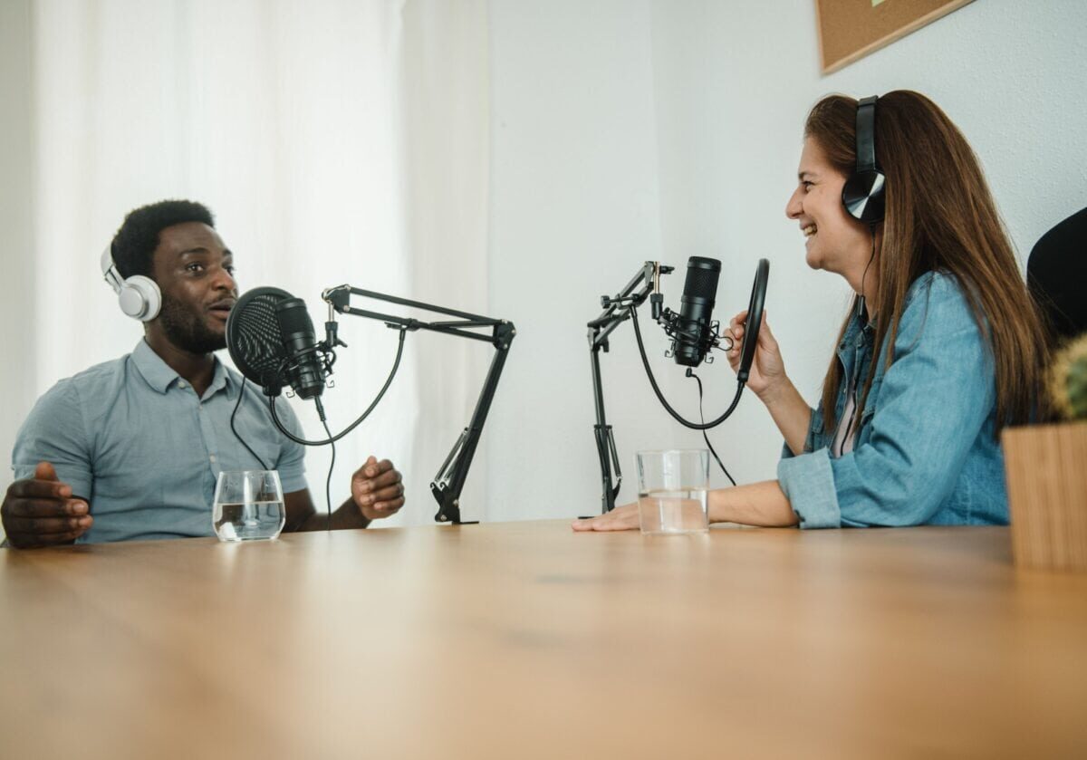 Image of two people conducting a podcast or radio interview.