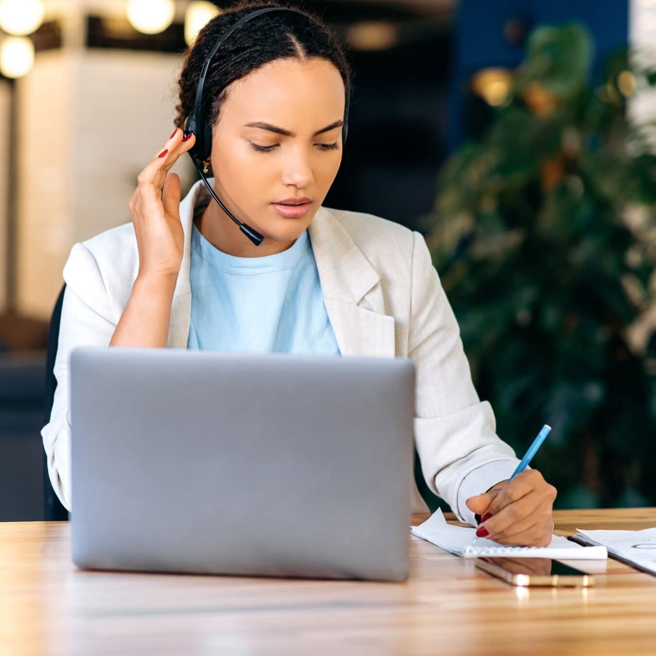 A woman dives into the ICF Research portal through her laptop in a small office.