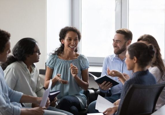 coach speaking to a professional group in a group coaching session