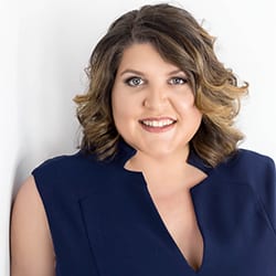 Melissa DiMercurio ACC headshot photo, brown haired woman in navy top smiling