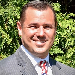 Robert Fluharty ACC PCC headshot photo, smiling man in suit outside