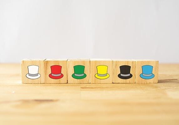 blocks lined up with different colored hats printed on them