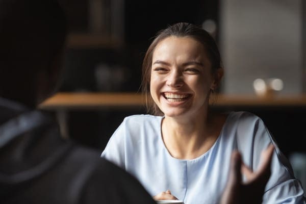 woman laughing and connecting with her coach