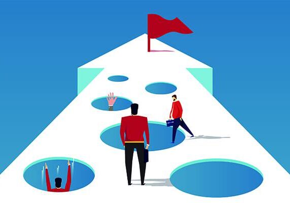 arrow pathway with holes and a red finish flag at the end one person standing ready to navigate while others have fallen into some holes
