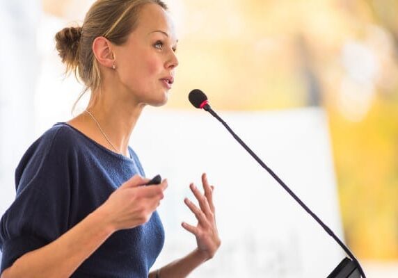 female speaker at a podium