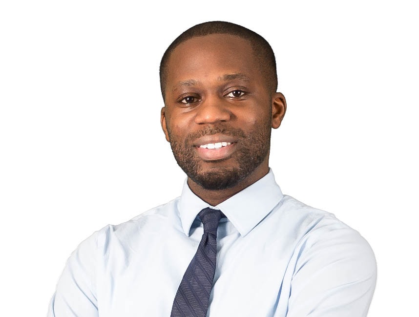 Tolu Akande MCC headshot photo, smiling man wearing light button up shirt and gray tie in front of white background