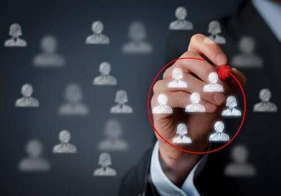 person circling a number of people icons on glass