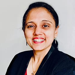 Vijayalakshmi S MCC headshot photo, woman smiling with dark hair