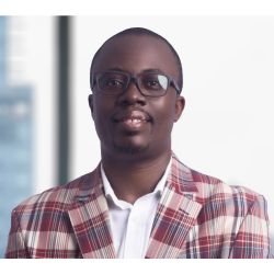 Scofray Nana Yaw Yeboah PCC headshot photo, man with glasses red plaid blazer and white shirt smiling