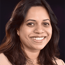 Rachel Gojer PCC ACTC BE ITCA headshot photo, woman with dark hair against black background smiling
